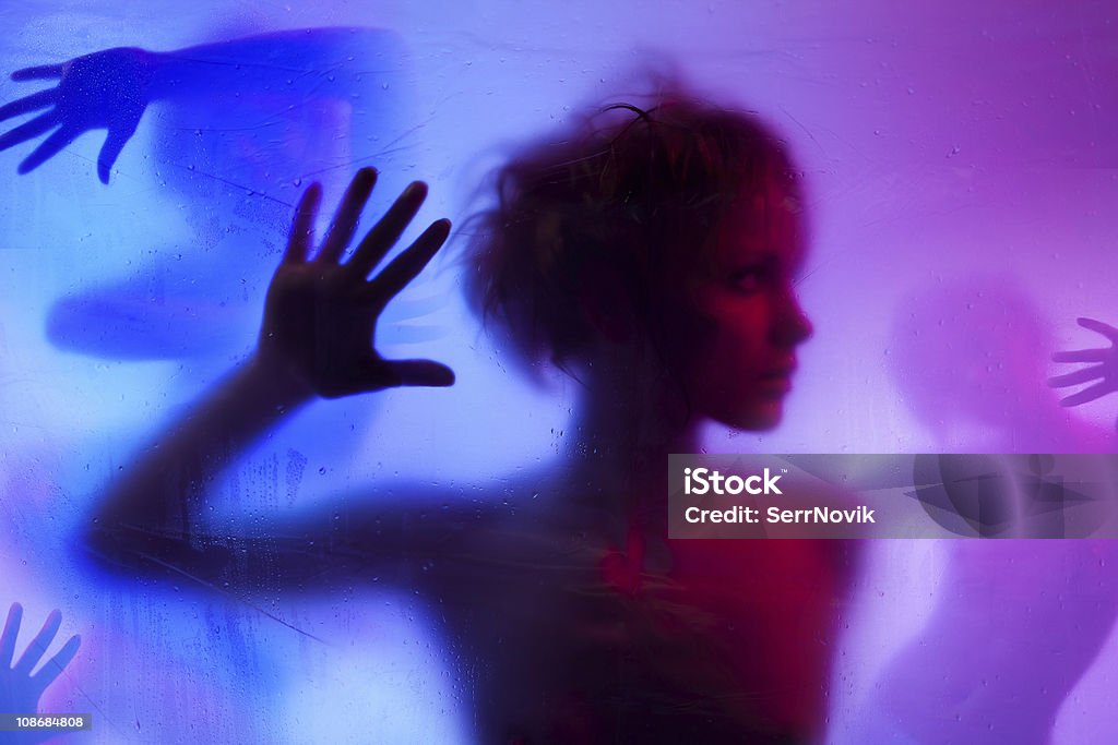 Silhouette  of young woman Silhouette  of young woman listening standing behind curtain Adult Stock Photo