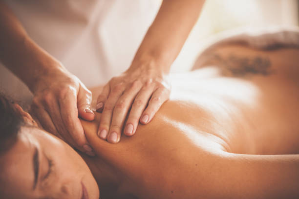 istock Massage therapist massaging woman's shoulders 1086848136