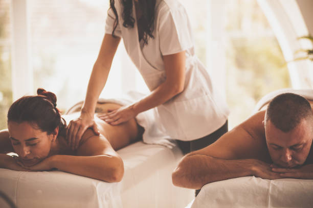 Man And Woman Enjoying Couples Massage At Spa Stock Photo - Download Image  Now - 30-39 Years, 40-44 Years, Adult - iStock