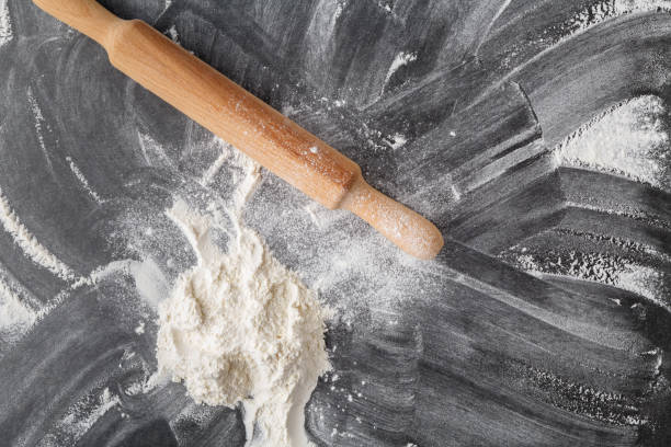 istock white flour with a rolling pin on a black background 1086851914