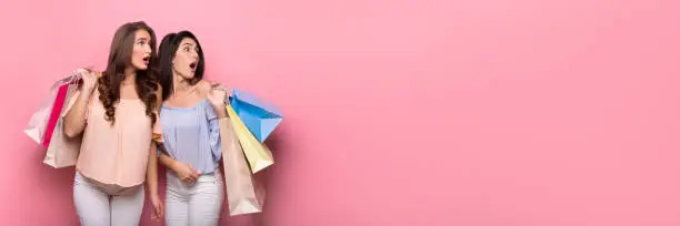 Photo of Shocked sad women holding packages after shopping