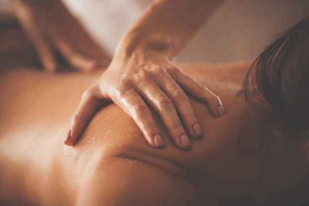 istock Beautician rubbing woman's back with scrub 1086852370