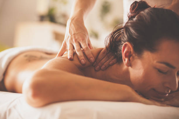 istock Relaxed woman enjoying back and shoulder massage at spa 1086852530