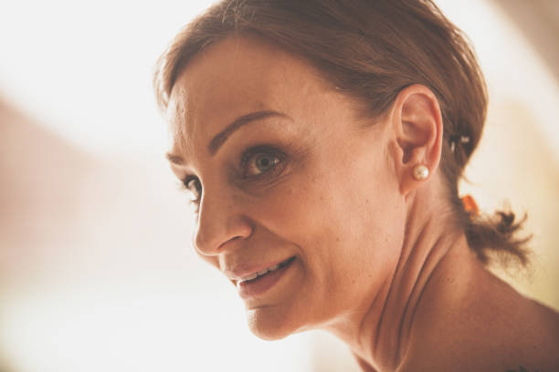 istock Smiling mature woman with blue eyes 1086854274