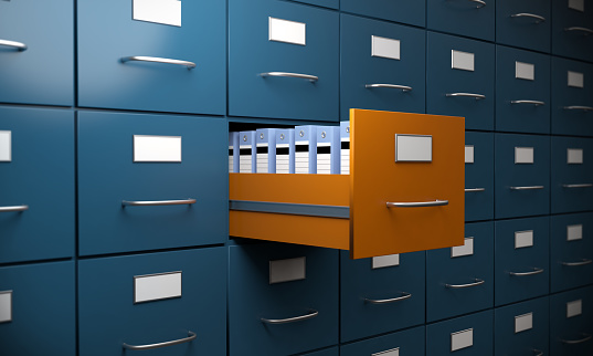 Orange colored filing cabinet between the blue ones. ( 3d render )