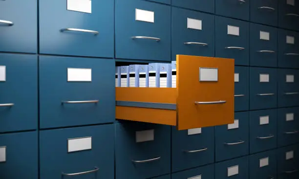 Orange colored filing cabinet between the blue ones. ( 3d render )