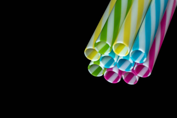istock 0596 Colourly striped plastic drinking straws, black underground background 1086859686
