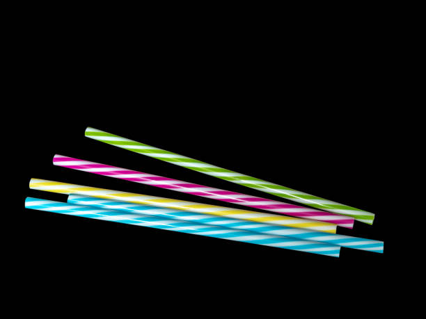 istock Piles of colorful striped plastic drinking straw, black underground 1086859822