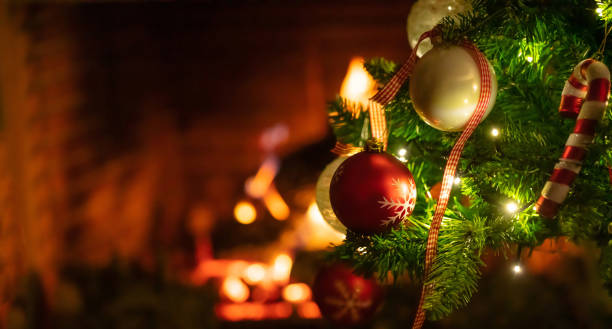 istock Christmas tree close up on blurred burning fireplace background 1086861710