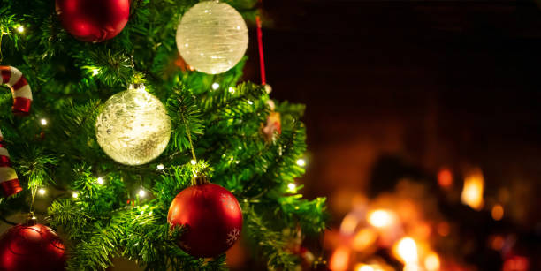 istock Christmas tree close up on blurred burning fireplace background 1086861744