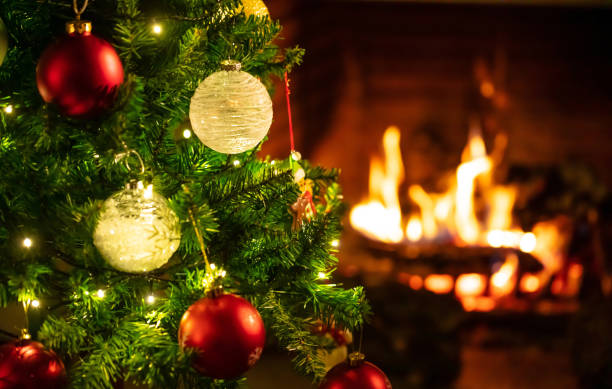 istock Christmas tree close up on blurred burning fireplace background 1086861772
