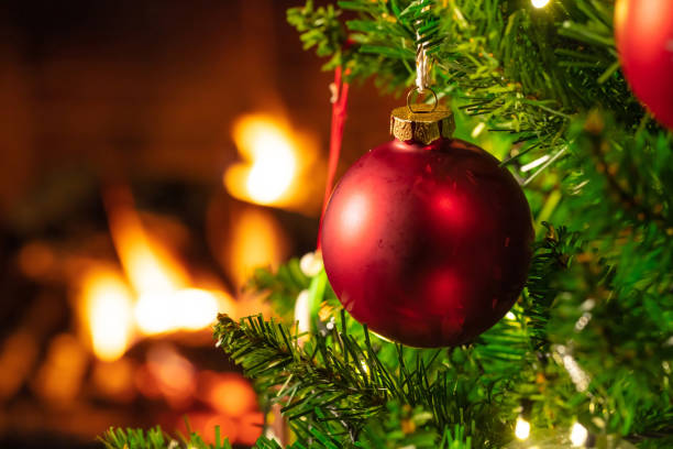 istock Christmas tree close up on blurred burning fireplace background 1086861774
