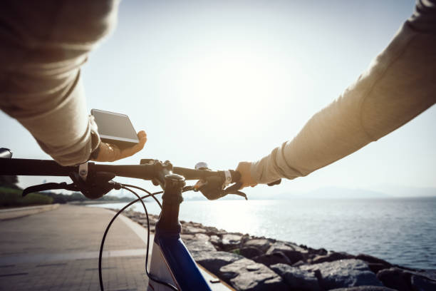 istock Cyclist using smartphone for navigation when riding mountain bike on the coast path 1086866492