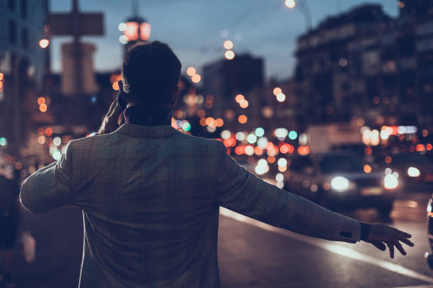 istock Busy young man catching the car while standing next to the road 1086873032
