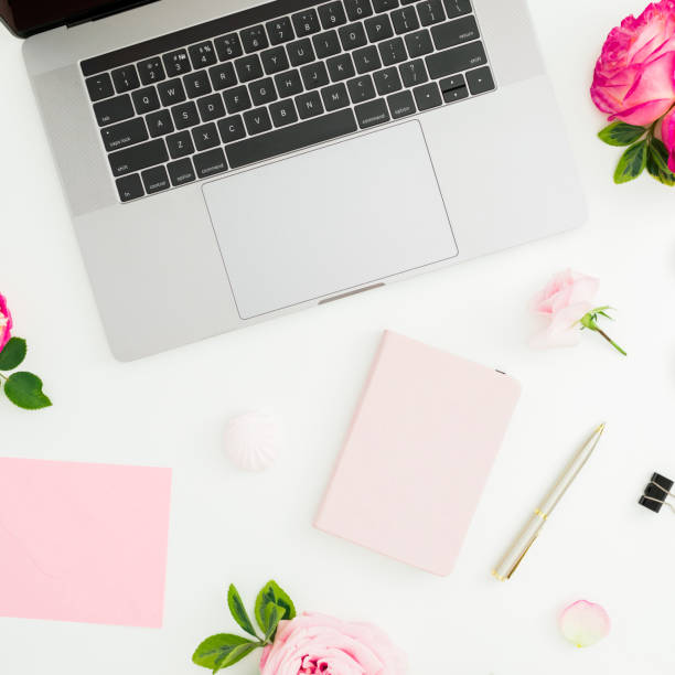 istock Laptop, roses flowers, diary, pen, envelope and petals on white background. Flat lay. Top view. 1086874822
