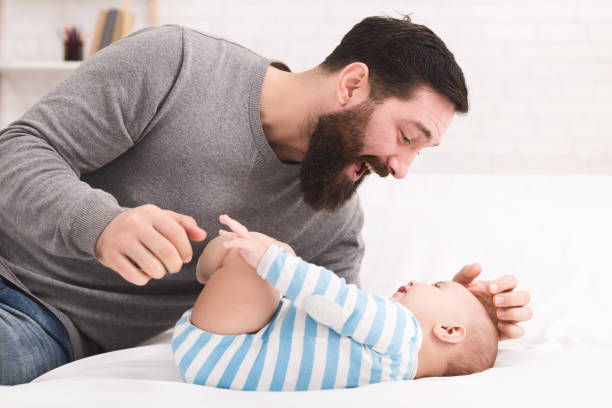 istock Father tickling and snuggling his baby son 1086875280