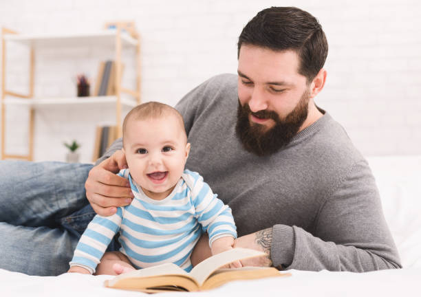 istock Father and reading book to little baby 1086875288