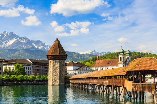 Chapel Bridge (Kapellbrucke) across the Reuss river and octagonal water tower, the main tourist attraction of Lucerne, Switzerland