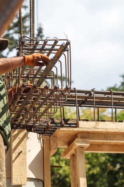 istock Worker ties steel reinforcing bars with wire. 1086878058