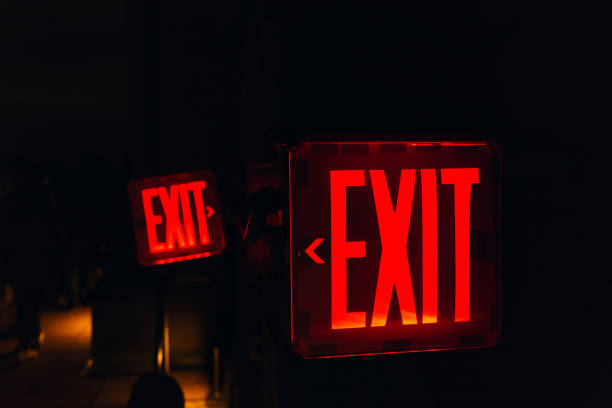 istock close up view of red exit sign on black backdrop 1086880140