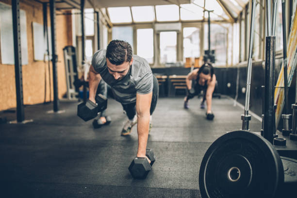 istock Fitness coach doing push-ups with women in gym 1086880644