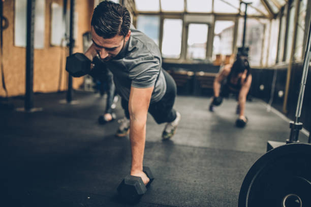 istock Fitness coach doing push-ups with two women 1086880670