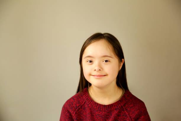 istock Down syndrome girl on the brown background 1086883948