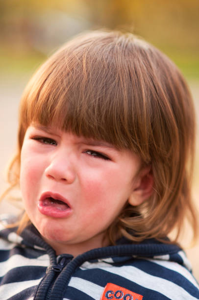 istock Adorable little boy crying, looking at camera 1086887102