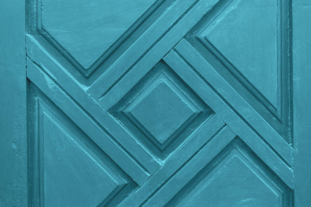 istock Wooden blue background with carved ornament. 1086889328