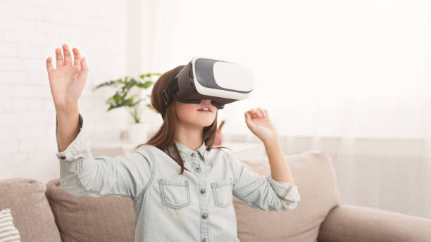 istock Girl wearing virtual reality glasses playing games 1086891948