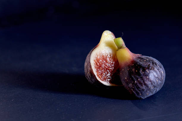 istock Beautiful Fresh figs on black background 1086892168
