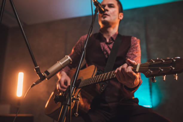istock Guy singing and playing acoustic guitar 1086893642