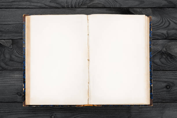 Old open book with blank pages on wooden table. Template and background