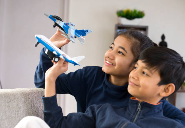 istock Children playing with toy airplane 1086904078