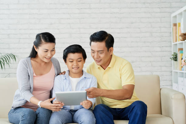 istock Family watching movie on digital tablet 1086913886