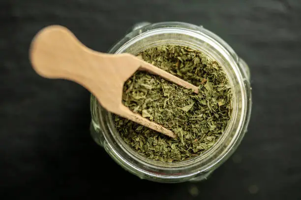 Dried thyme on wooden spoon