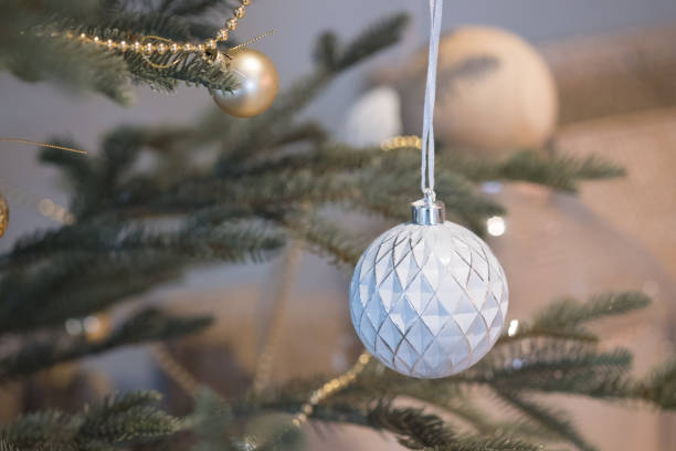 istock White Christmas ornaments hanging from Christmas tree 1086920306