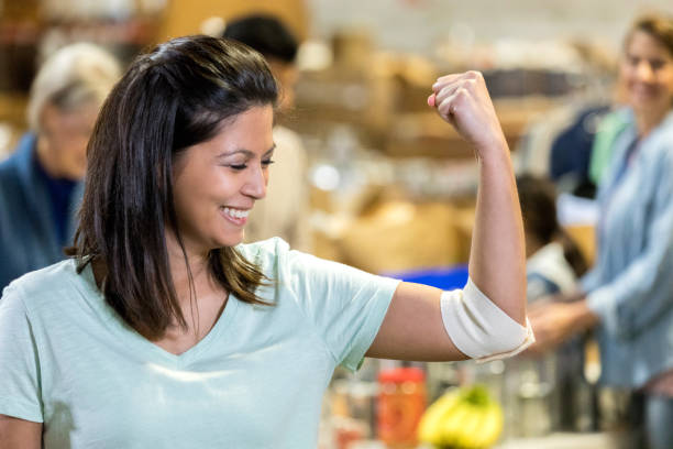 istock Woman flexes muscles after donating blood 1086922494
