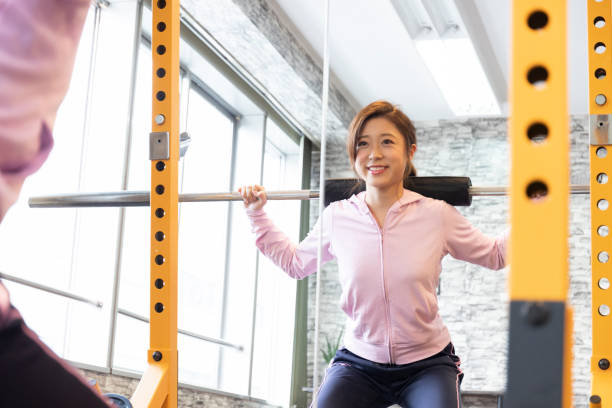 istock A woman lifting a barbell 1086924956