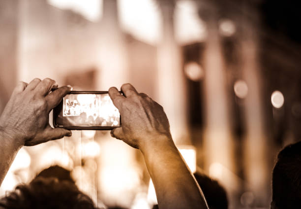 istock Man recording event with cellphone 1086935362