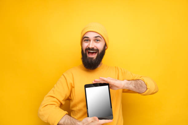 istock Bright male model with tablet for sale 1086941066