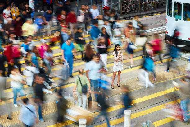 istock Businesswoman using mobile phone amidst crowd 1086946356