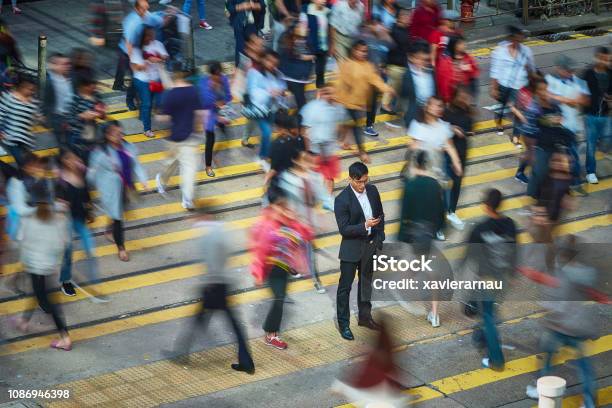 Geschäftsmann Mit Smartphone In Menge Stockfoto und mehr Bilder von Menschenmenge - Menschenmenge, Menschen, Gegen den Strom