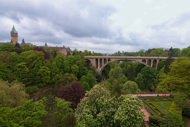 Garden and Adolphe bridge over Petrusse valley in Luxembourg city. Spring urban landscape photo. Luxembourg, Grand Duchy of Luxembourg Garden and Adolphe bridge over Petrusse valley in Luxembourg city. Spring urban landscape photo. Luxembourg, Grand Duchy of Luxembourg. petrusse stock pictures, royalty-free photos & images