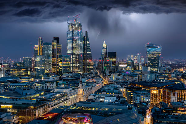 die beleuchtete city of london mit einem gewitter und dunkle wolken - london in the rain stock-fotos und bilder
