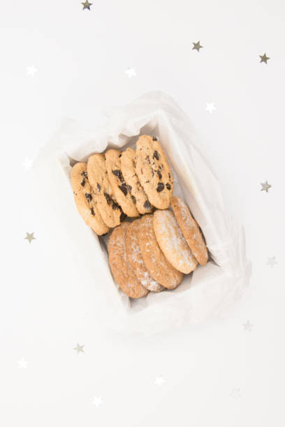 istock Cookies in a box on a whitebackground with silver stars confetti. Holiday concept. 1086950946