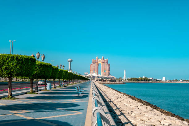 Abu Dhabi skyline waterfront Perspective view of the Abu Dhabi Corniche promenade with view to Marina island. corniche photos stock pictures, royalty-free photos & images