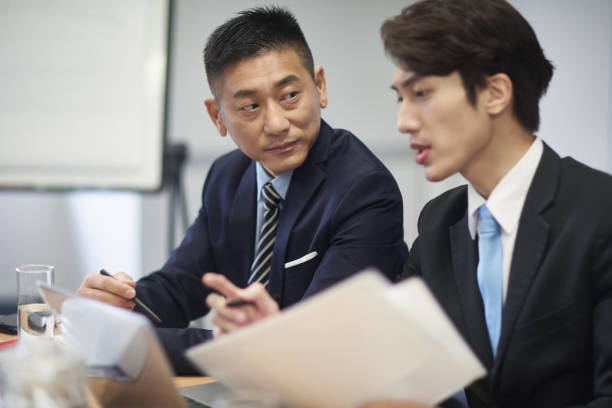 istock Mature businessman discussing with colleague 1086951336