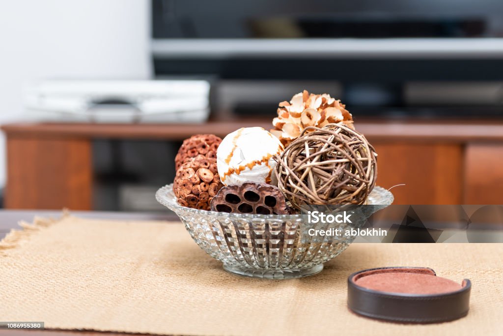 Modern, contemporary, clean decor with vase on table, tablecloths, coaster set, wicker balls, cone, apartment, home, house in living room, TV Design Stock Photo