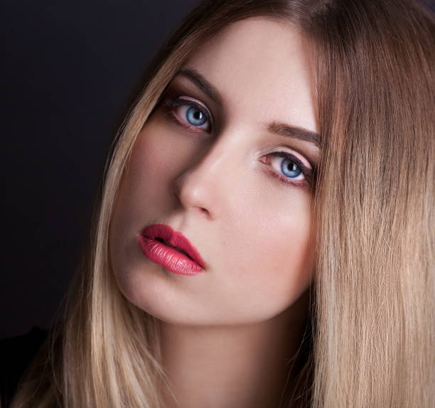 istock Face, blue eyes, black background, ombre hair 1086955382